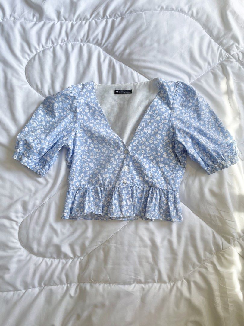 Zara Floral Puff Sleeve Top (Category: Blouses) located in Quezon City. Submitted by fudge.brownies (Listing ID 1433111274, Image 1). Description: Can fit XS-S Has inner lining vv cute pastel blue🩵 had a hole stitched on the side lang, but overall in good condition.