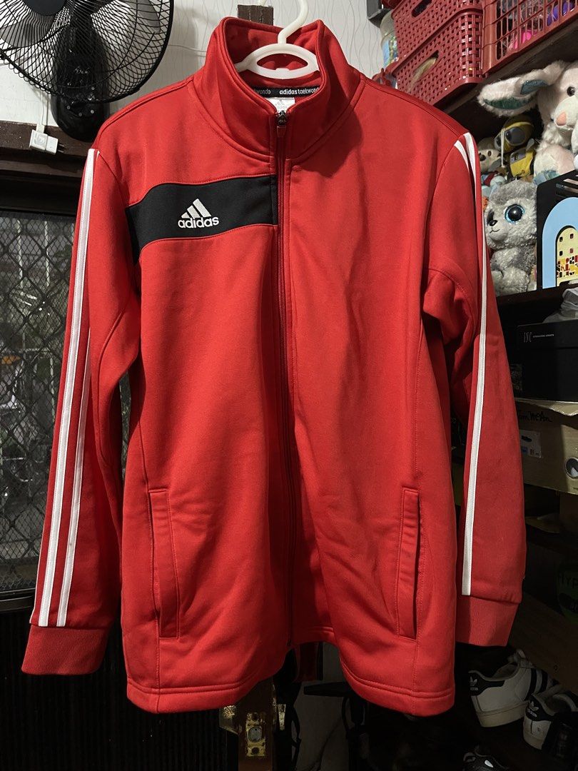Adidas Red Track Jacket (Category: Coats, Jackets and Outerwear) located in Manila. Submitted by jiahhncarl57791 (Listing ID 1437501435, Image 1). Description: - Adidas track jacket - Red with white stripes - Black chest panel with Adidas logo - Adidas logo on the back - Full zip closure - Two side pockets - Climawarm technology.
