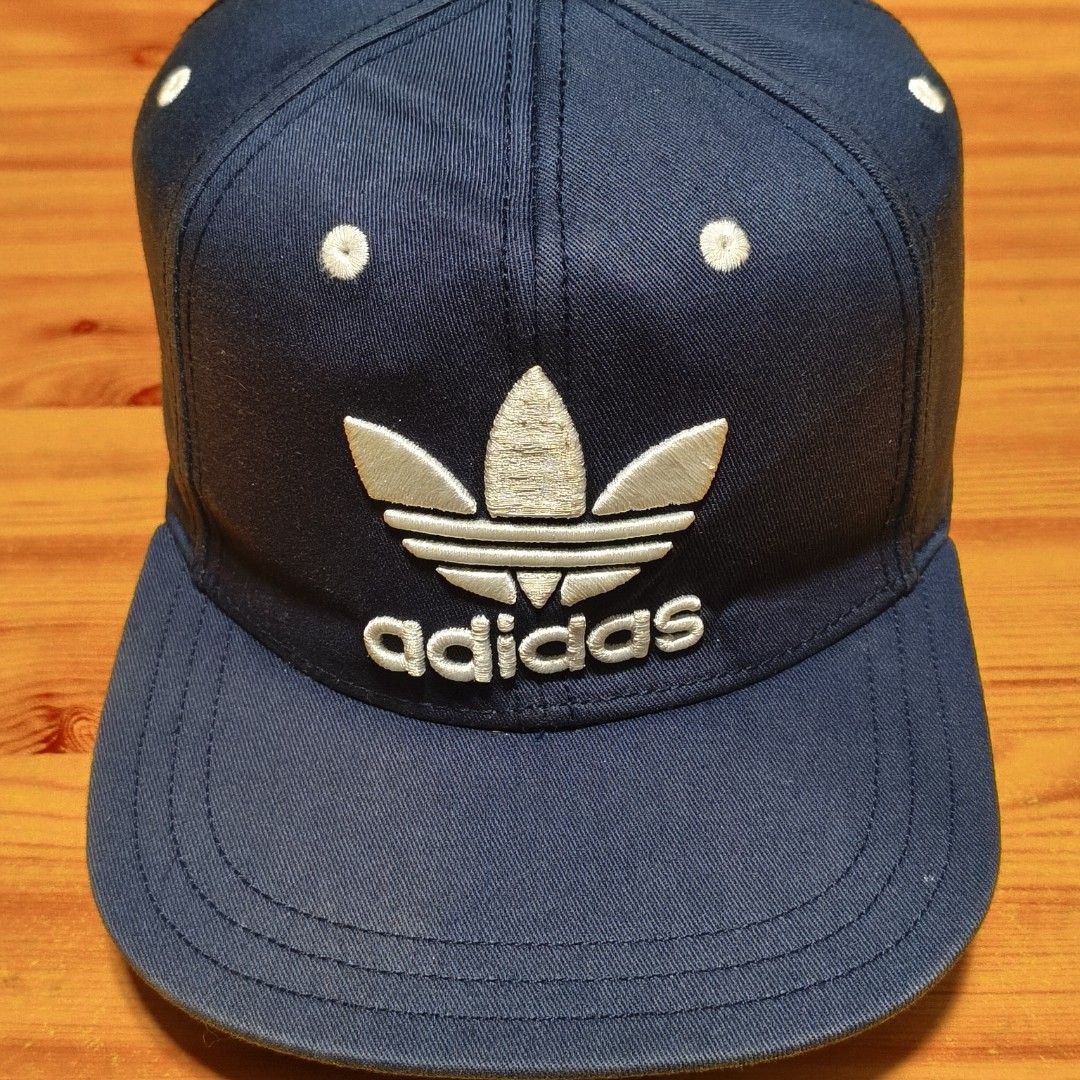 Adidas Trefoil Cap - Navy Blue (Category: Caps & Hats) located in Manila. Submitted by caps08 (Listing ID 1437457777, Image 3). Description: - Adidas Trefoil logo cap - Navy blue with white accents - Features a flat brim - Adjustable strap for a perfect fit - Adidas logo on the back - Made of durable fabric.