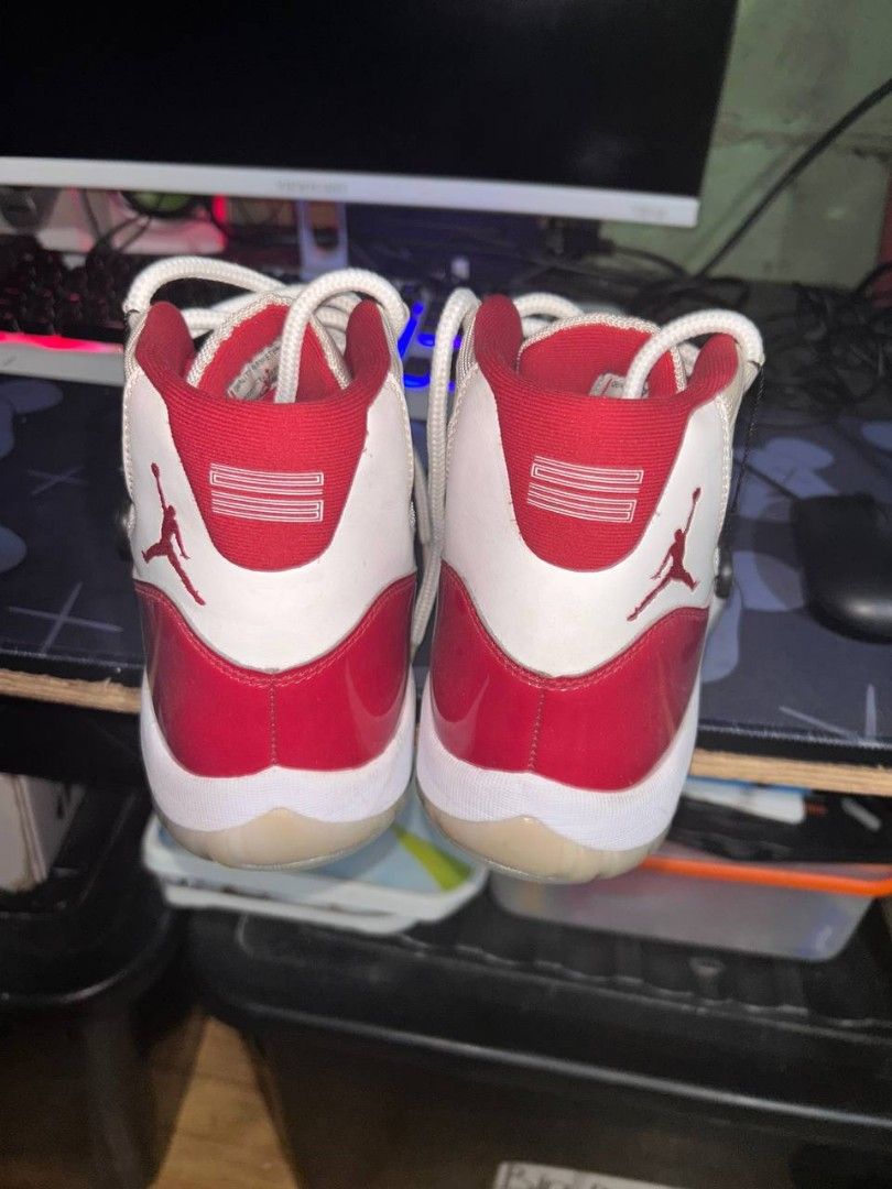Air Jordan 11 Retro Cherry (Category: Sneakers) located in Manila. Submitted by stylish_thrift (Listing ID 1437494197, Image 2). Description: - Air Jordan 11 Retro 'Cherry' - Red patent leather upper - White mesh and accents - White laces - Translucent outsole - Jumpman logo visible - Yellowish Color - 4 Times used - 16,000 ORIG Price - Buy in shoe game manila - With box but sira konti sa katagalan - Negotiable - Can do meetupo or video call to c