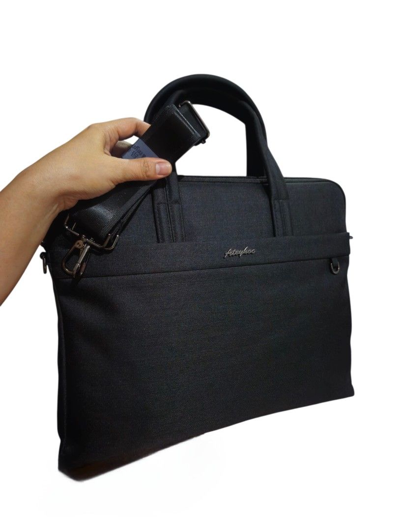 Laptop bag Briefcase (Category: Laptop Bags & Sleeves) located in Quezon City. Submitted by kirstenbella (Listing ID 1437493967, Image 1). Description: - Ateyhoc brand - Detachable shoulder strap - Thick top handle - Wide magnetic front compartment - Zippered main compartment - Wide back zip compartment - Interior pockets - Fun metal toned hardware - Made of durable, textured fabric - H15 x W12 x D2 Inches - Brand new padala .