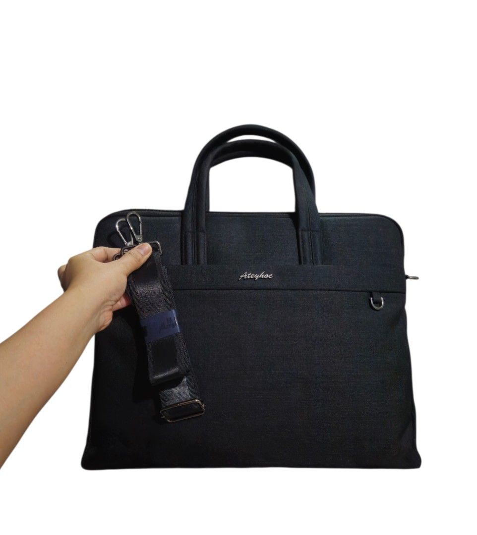 Laptop bag Briefcase (Category: Laptop Bags & Sleeves) located in Quezon City. Submitted by kirstenbella (Listing ID 1437493967, Image 2). Description: - Ateyhoc brand - Detachable shoulder strap - Thick top handle - Wide magnetic front compartment - Zippered main compartment - Wide back zip compartment - Interior pockets - Fun metal toned hardware - Made of durable, textured fabric - H15 x W12 x D2 Inches - Brand new padala .
