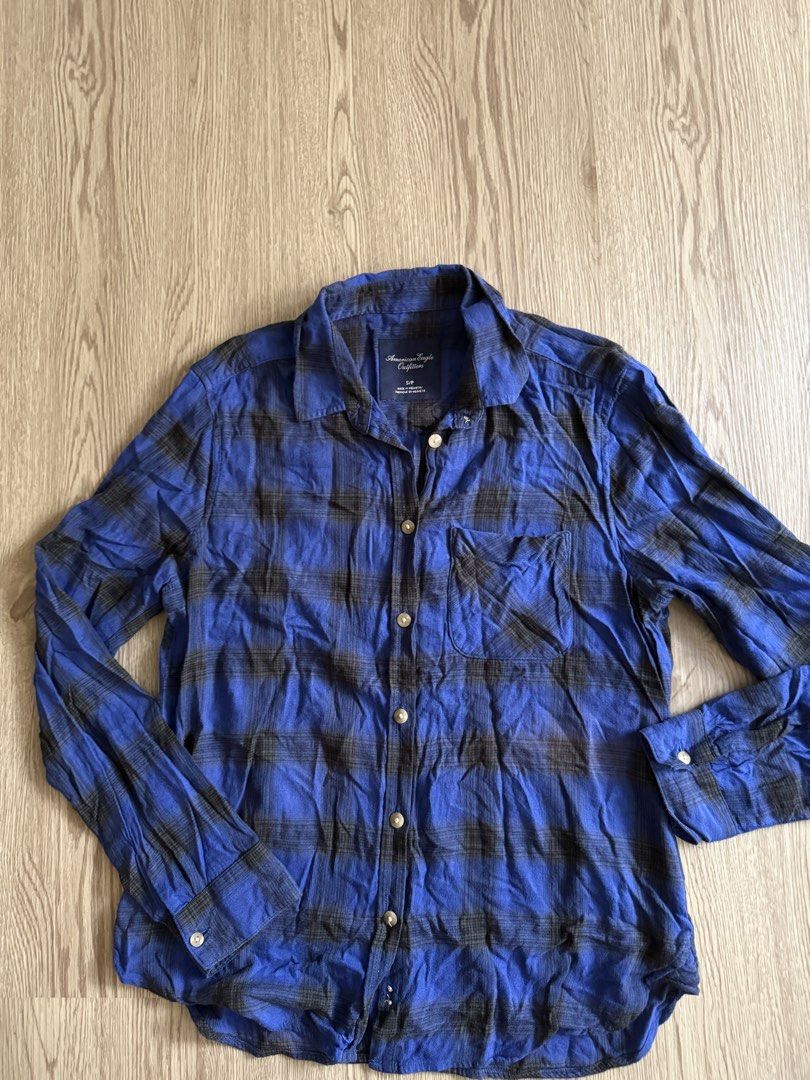 American Eagle Outfitters Plaid Shirt (Category: Tshirts & Polo Shirts ) located in Pasig City. Submitted by anjeg (Listing ID 1437406972, Image 2). Description: - American Eagle Outfitters plaid shirt - Color: Blue and black - Size: S/P - Features: Button-down front, single chest pocket, long sleeves with buttoned cuffs - Classic collar - Made in Indonesia.