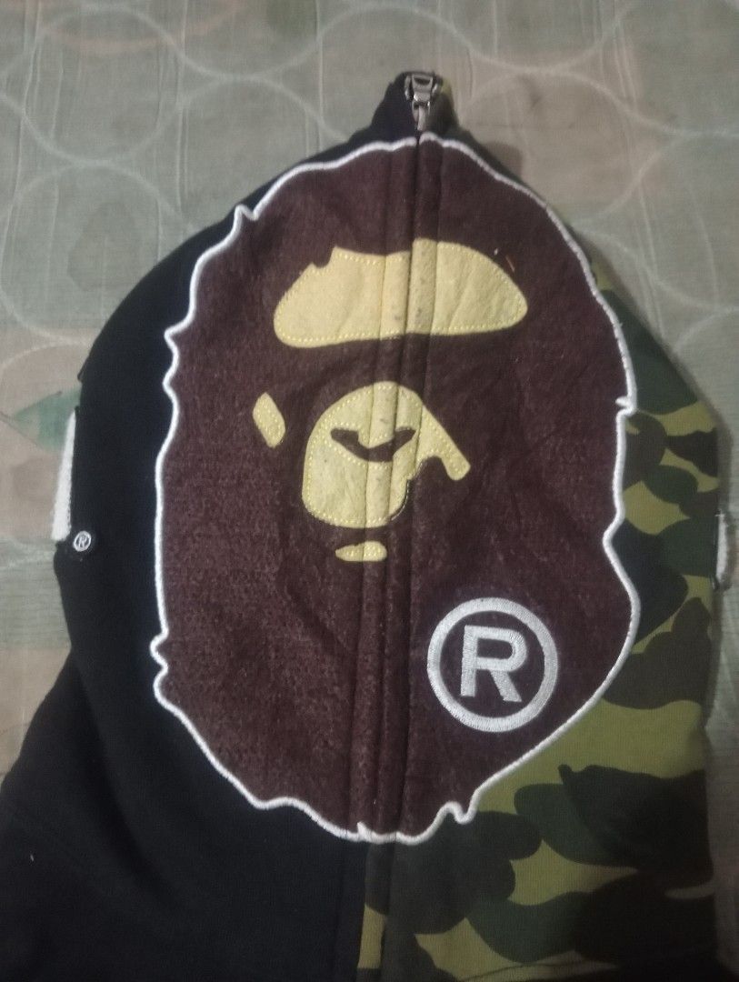 BAPE Full Zip Hoodie (Category: Hoodies) located in Bolinao. Submitted by willaskyle19427 (Listing ID 1437420550, Image 2). Description: - Black BAPE full zip hoodie - Camo-patterned hood - Iconic BAPE ape head on hood - BAPE logo on sleeves - White logo on sleeve - Visible tag fake/legit check the tag issue:may puti puti .
