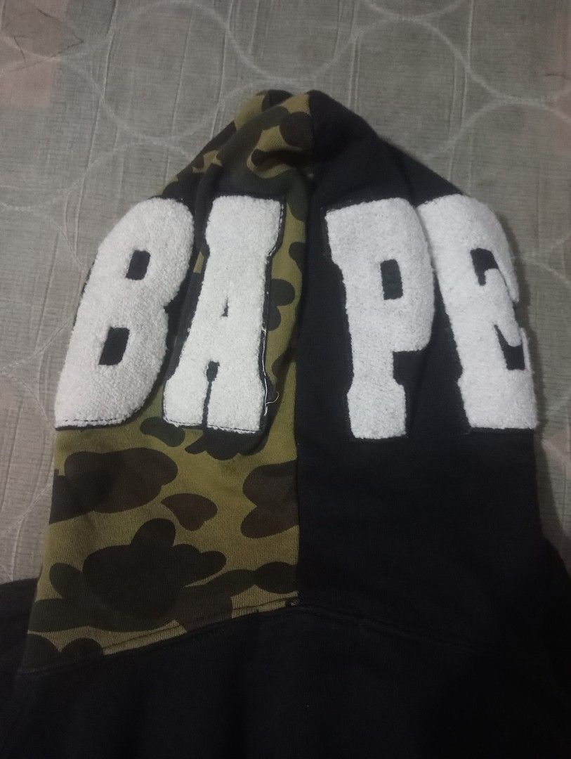 BAPE Full Zip Hoodie (Category: Hoodies) located in Bolinao. Submitted by willaskyle19427 (Listing ID 1437420550, Image 3). Description: - Black BAPE full zip hoodie - Camo-patterned hood - Iconic BAPE ape head on hood - BAPE logo on sleeves - White logo on sleeve - Visible tag fake/legit check the tag issue:may puti puti .