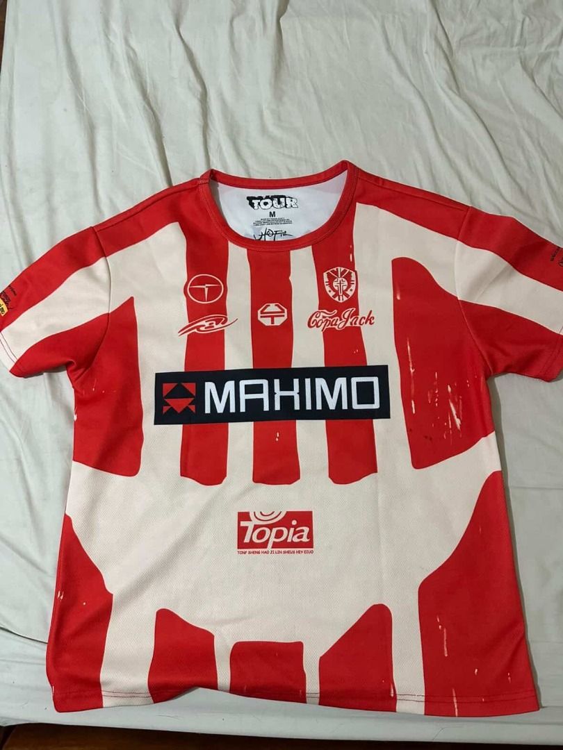 cactus jack UTopia Maximo soccer football Jersey size medium (Category: Shirts) located in Quezon City. Submitted by dune--closet (Listing ID 1437512702, Image 1). Description: - Red and white striped jersey - Features "MAXIMO" on the front - "Atobia" and "2" on the back - Includes a graphic design at the bottom - Round neck and short sleeves - Size: M.