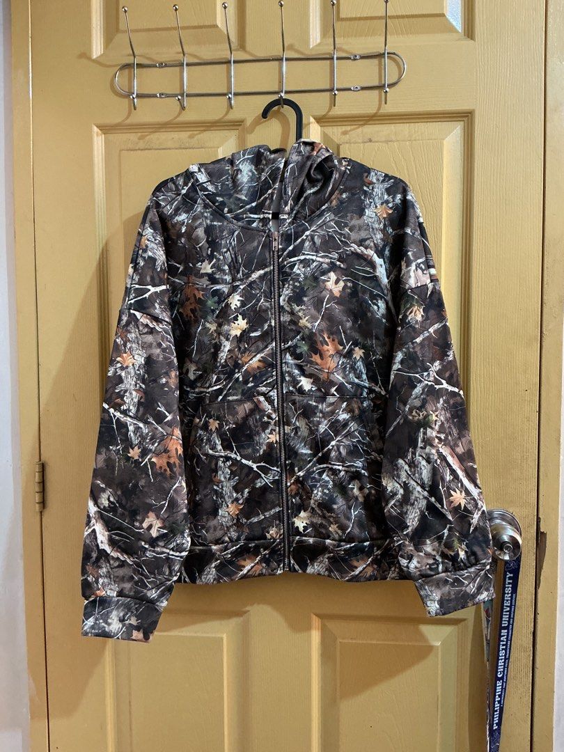 Camouflage Zip-Up Hoodie (Category: Coats, Jackets and Outerwear) located in General Trias. Submitted by micsyyyyy (Listing ID 1437453848, Image 1). Description: - Camouflage pattern - Zip-up front - Hooded - Two front pockets - Ribbed cuffs and hem - Soft material - Polyester .