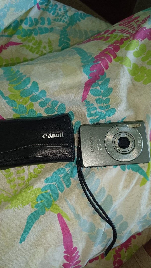 Canon Digital IXUS 75 Camera (Category: Cameras) located in Taguig. Submitted by redarmy21775000 (Listing ID 1437407398, Image 2). Description: - Canon Digital IXUS 75 camera - Silver color - 7.1 MP lens - Includes black Canon case - Comes with wrist strap - Screen has some scratches - no battery - with sd card 2gb - not sure if working.