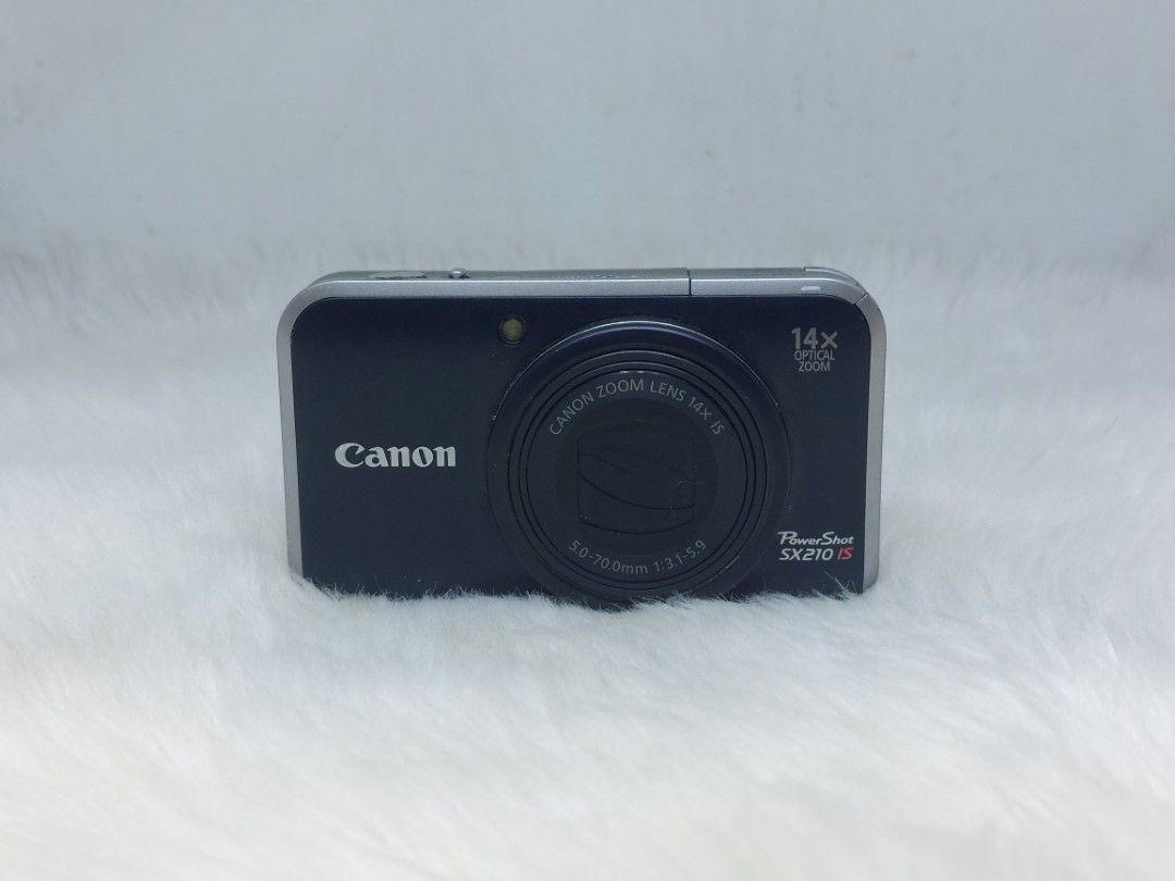 Canon PowerShot SX210 IS (defective) (Category: Cameras) located in Manila. Submitted by jonrick.co (Listing ID 1437523543, Image 1). Description: - Canon PowerShot SX210 IS digital camera - 14x digital zoom lens - Sleek black body with silver trim - Features a display screen - Includes various function buttons - Canon logo visible defective no power for display or parts out or repair selling as is no return no exchange.