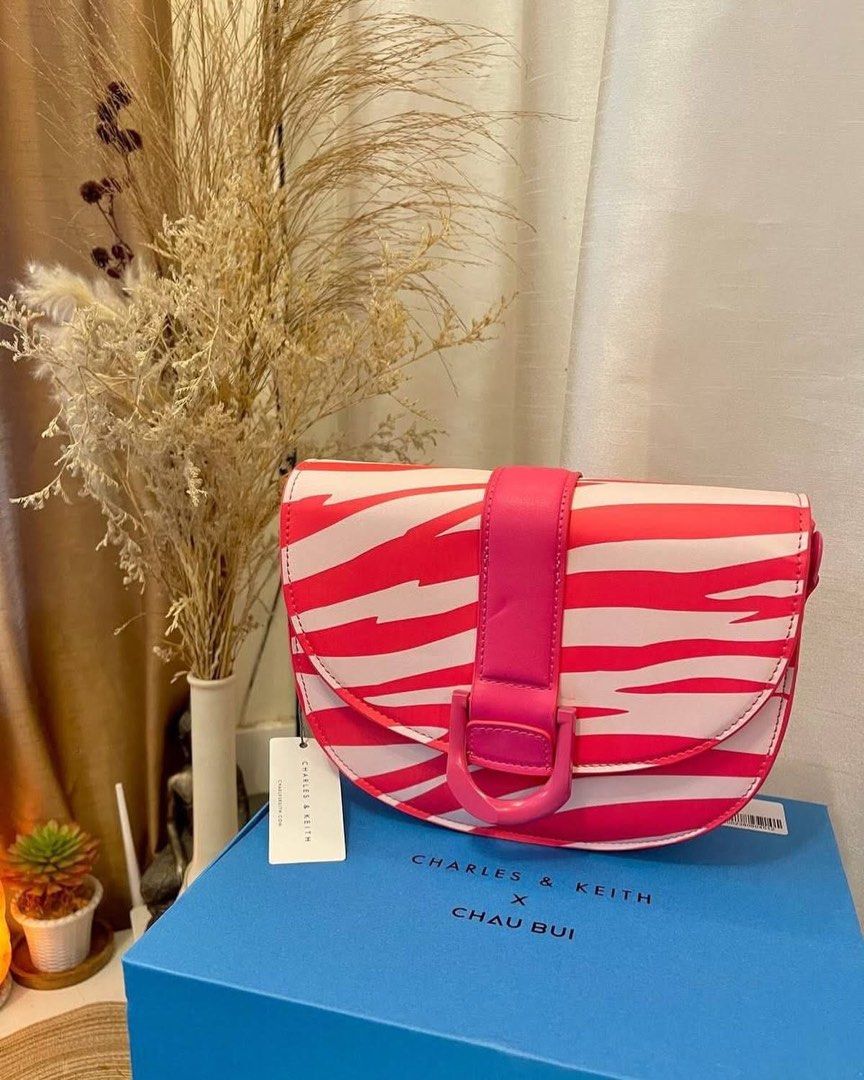 Charles & Keith - Zebra Print Gabine Saddle Bag (Category: Cross-body Bags) located in Manila. Submitted by lustrouselegance (Listing ID 1437550125, Image 1). Description: single handle magnetic closure comes with one short non-adjustable strap and one long adjustable strap material: Faux leather depth (cm): 6.5 width (cm): 23 height (cm): 18.