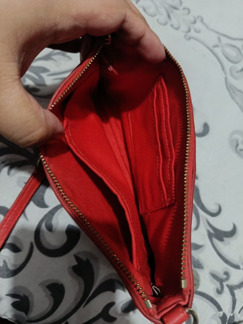 Original Coach Red Crossbody Bag (Category: Luxury Bags & Wallets) located in Subic. Submitted by yssacollection (Listing ID 1437500106, Image 3). Description: •Pebbled Leather • GOLD HARDWARE • Inside multifunction pocket • Zip top closure • Back card pocket • Fabric lining • Adjustable leather strap for shoulder or crossbody wear L 8.5" x H 4.75" x W 1.5" - Authentic Coach crossbody bag - Eye-catching red color - Elegant gold chain strap - Secu