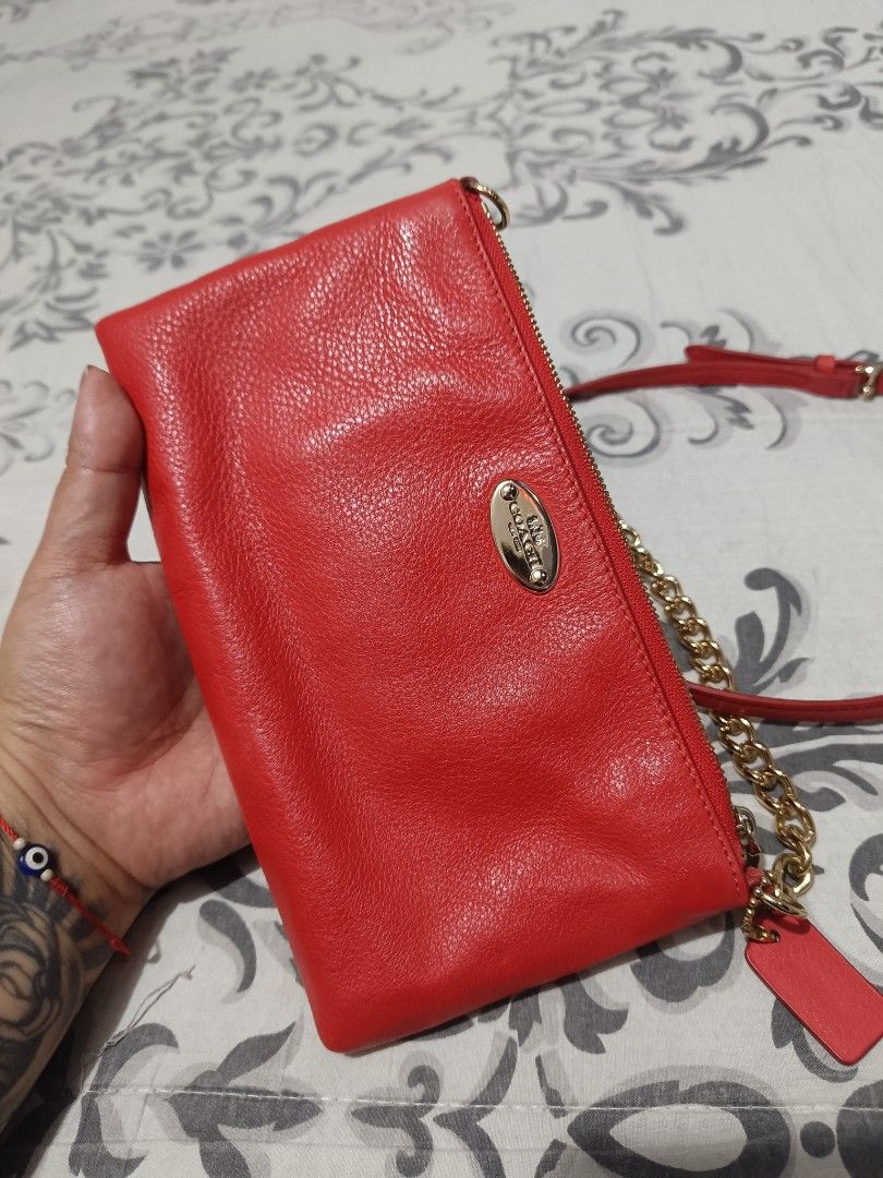 Original Coach Red Crossbody Bag (Category: Luxury Bags & Wallets) located in Subic. Submitted by yssacollection (Listing ID 1437500106, Image 2). Description: •Pebbled Leather • GOLD HARDWARE • Inside multifunction pocket • Zip top closure • Back card pocket • Fabric lining • Adjustable leather strap for shoulder or crossbody wear L 8.5" x H 4.75" x W 1.5" - Authentic Coach crossbody bag - Eye-catching red color - Elegant gold chain strap - Secu