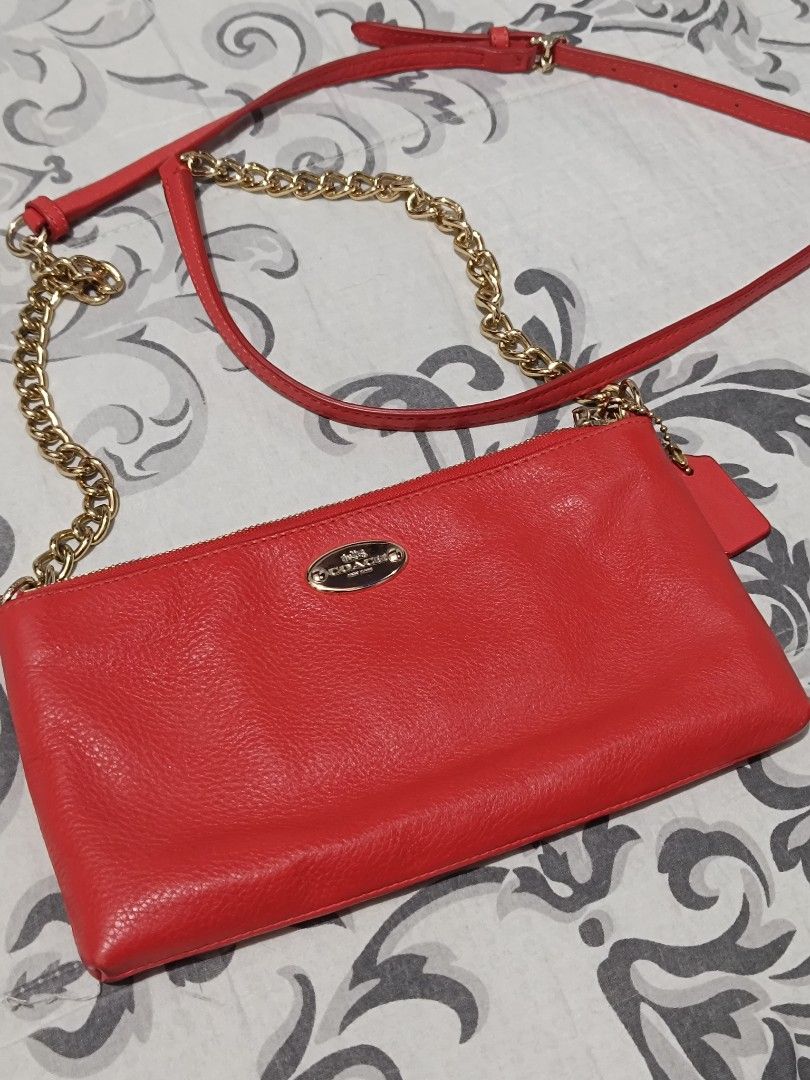 Original Coach Red Crossbody Bag (Category: Luxury Bags & Wallets) located in Subic. Submitted by yssacollection (Listing ID 1437500106, Image 1). Description: •Pebbled Leather • GOLD HARDWARE • Inside multifunction pocket • Zip top closure • Back card pocket • Fabric lining • Adjustable leather strap for shoulder or crossbody wear L 8.5" x H 4.75" x W 1.5" - Authentic Coach crossbody bag - Eye-catching red color - Elegant gold chain strap - Secu