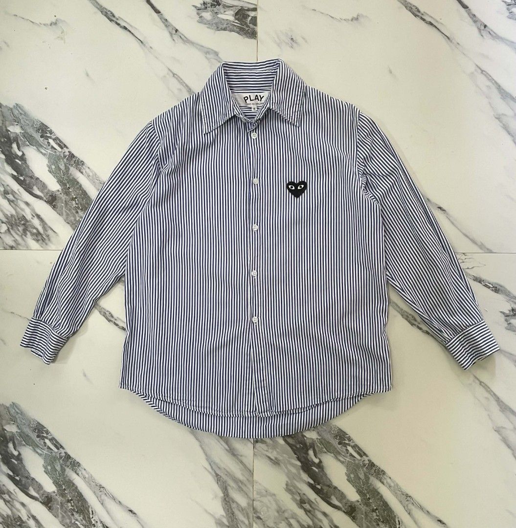 Comme des Garcons Play Striped Shirt (Category: Shirts) located in Caloocan City. Submitted by maitumroye57862 (Listing ID 1437431840, Image 1). Description: - Comme des Garcons Play shirt - Size: S - Features the iconic heart logo - Striped pattern (blue and white) - Classic collar and button-down - Long sleeves - Made in Japan.
