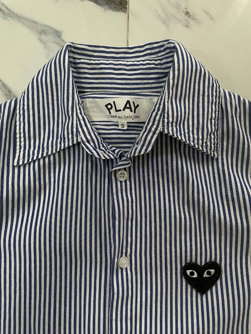 Comme des Garcons Play Striped Shirt (Category: Shirts) located in Caloocan City. Submitted by maitumroye57862 (Listing ID 1437431840, Image 2). Description: - Comme des Garcons Play shirt - Size: S - Features the iconic heart logo - Striped pattern (blue and white) - Classic collar and button-down - Long sleeves - Made in Japan.
