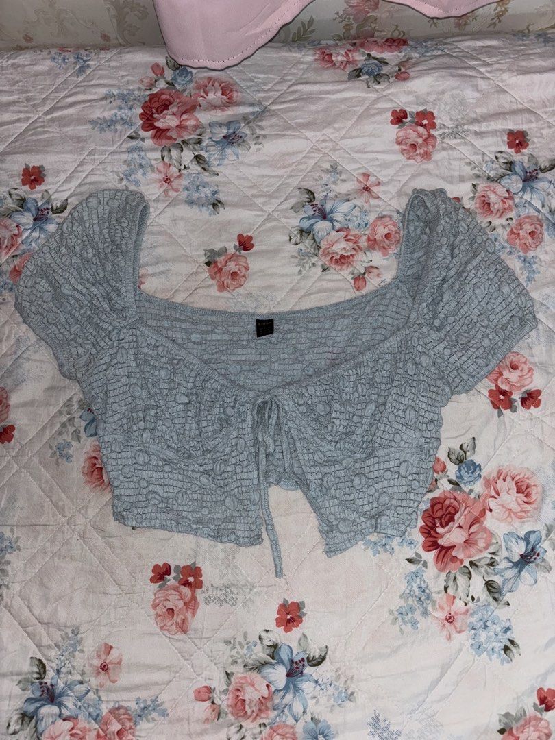 Coquette Blue Crop Top Puff Sleeve (Category: Others Tops) located in Quezon City. Submitted by samae_zzang (Listing ID 1437521252, Image 1). Description: - Light blue crop top - Square neckline - Short sleeves - Tie detail at front - Textured, crinkled fabric - Perfect for a casual, summery look.