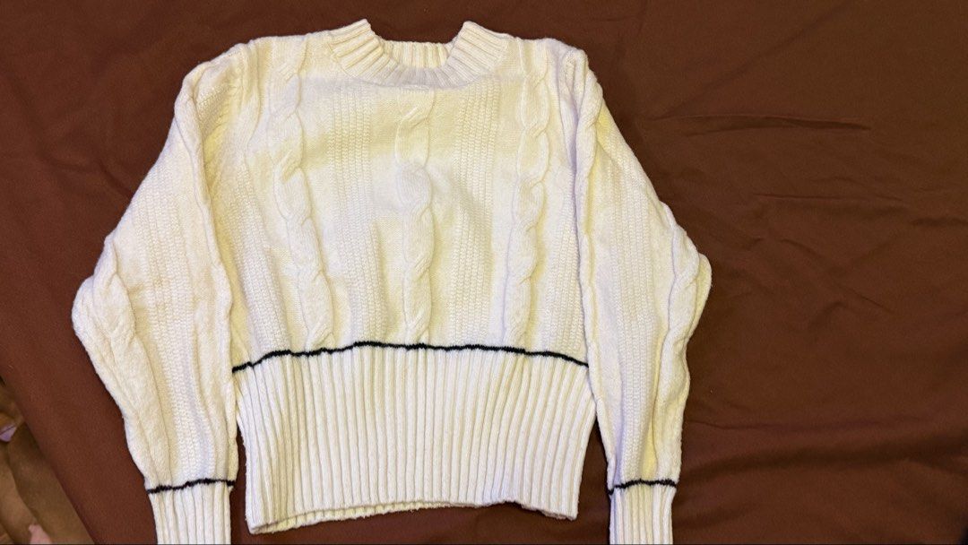 Cream Cable Knit Sweater with Black Trim (Category: Longsleeves) located in Quezon City. Submitted by shejyy (Listing ID 1437410689, Image 1). Description: Cream-colored sweater features a classic cable knit design. It has a crew neck and long sleeves. The sweater is accented with a black trim along the waist and cuffs. The overall style is simple yet stylish..