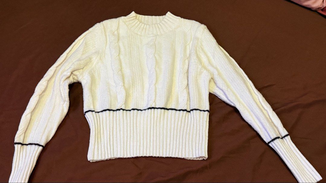 Cream Cable Knit Sweater with Black Trim (Category: Longsleeves) located in Quezon City. Submitted by shejyy (Listing ID 1437410689, Image 2). Description: Cream-colored sweater features a classic cable knit design. It has a crew neck and long sleeves. The sweater is accented with a black trim along the waist and cuffs. The overall style is simple yet stylish..