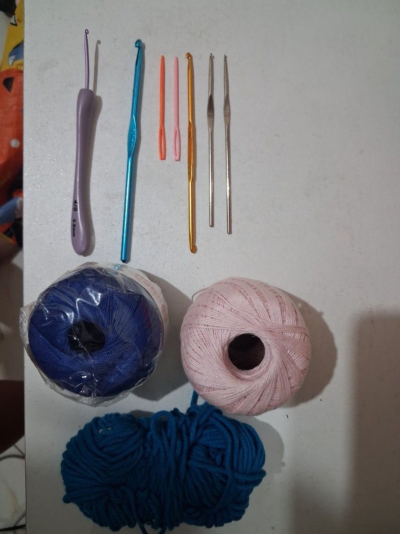 Crochet Hooks and Yarn Set (Category: Craft Supplies & Tools) located in Caloocan City. Submitted by silentfox-8197 (Listing ID 1437562848, Image 1). Description: Hooks sizes: - 5.0 mm (blue) - 7 (silver) - 6 (silver) - 3/0 and 5/0 (dual) (gold) - 4/0 (2.5mm) purple RFS: change of hobby yarn: blue (with plastic) pink (slightly used) teal (slightly used) see photo for reference.