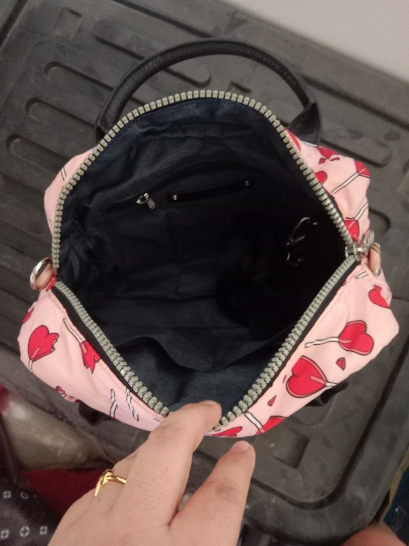 Diesel Heart Print Handbag (Category: Luxury Bags & Wallets) located in Bulacan. Submitted by chubbylicious (Listing ID 1437512651, Image 2). Description: - Diesel handbag with a fun heart print. - Features a top handle and a secure zip closure. - Includes a detachable shoulder strap. - Interior is black with a small pocket. - Authentic Diesel logo visible inside..