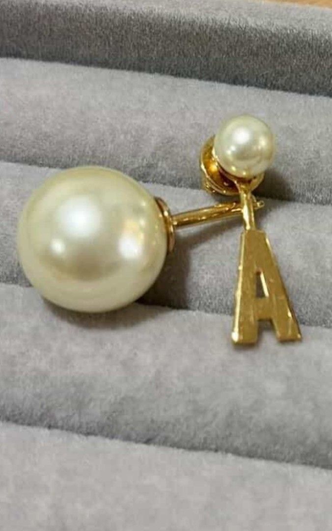 Dior earring (Category: Earrings) located in Rodriguez. Submitted by Branded100 (Listing ID 1437477424, Image 1). Description: NO TO SCAMMERS🚫 Mag ingat po sa mga scammer, nagkalat na po sila.. - Authentic Christian Dior Tribales Earrings - Features a pearl design - Includes a gold-tone "A" pendant - A stylish and elegant accessory.