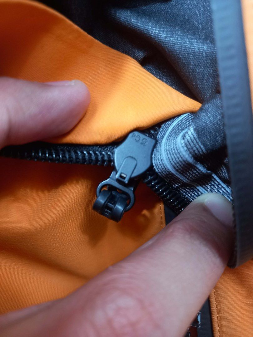 Dior Orange Nylon Hooded Jacket (Category: Coats, Jackets and Outerwear) located in Quezon City. Submitted by davidso682 (Listing ID 1437411349, Image 3). Description: - Dior orange hooded jacket - Full zip closure - Two zipped front pockets - Dior logo on sleeve - Black lining - Dior logo pattern on inside hem - Adjustable hood with drawstrings - Black zipper.
