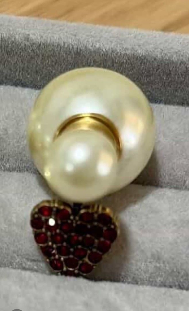 Dior Tribales Heart Earrings (Category: Earrings) located in Rodriguez. Submitted by Branded100 (Listing ID 1437476765, Image 1). Description: NO TO SCAMMERS🚫 Mag ingat po sa mga scammer, nagkalat na po sila.. - Dior Tribales earrings - Gold-tone metal - Red crystal heart detail - White resin pearls - Large pearl for the back of the ear - Small pearl for the front - Crafted with gold-finish metal, faux resin pearls, and red crystals..