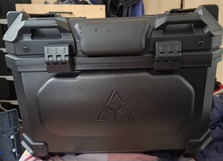 Duhan Top Box with (Category: Other Motorcycles Parts and Accessories) located in Taguig. Submitted by cessyago123 (Listing ID 1437445837, Image 1). Description: - Durable duhan motorcycle top box - Secure locking mechanism - Stylish black exterior - Padded interior - Includes mounting plate for easy installation - Comes with keys for added security - Perfect for helmets and luggage - Sleek design, ready to mount.