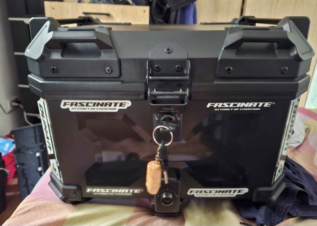 Duhan Top Box with (Category: Other Motorcycles Parts and Accessories) located in Taguig. Submitted by cessyago123 (Listing ID 1437445837, Image 3). Description: - Durable duhan motorcycle top box - Secure locking mechanism - Stylish black exterior - Padded interior - Includes mounting plate for easy installation - Comes with keys for added security - Perfect for helmets and luggage - Sleek design, ready to mount.