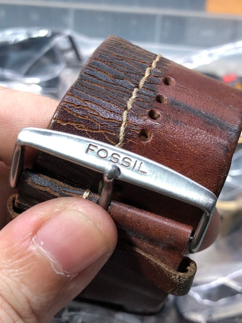 Fossil Blue 100M Watch (Category: Luxury Watches) located in Mandaluyong City. Submitted by kuya.marks.retro.gadgets (Listing ID 1437542436, Image 2). Description: Fossil watch with a silver-tone square face and brown leather cuff strap. The watch face has silver numerals and hands. The watch is marked "Fossil 100 Meters Blue". The strap has a buckle marked "Fossil". Issue: stiff leather bracelet but still usable (you can have it replaced).