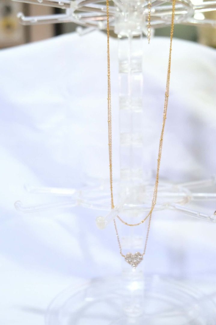Gold Heart Pendant Necklace (Category: Necklaces) located in Tarlac. Submitted by alleiz1521 (Listing ID 1437410831, Image 2). Description: - Gold double-layered chain necklace - Features a heart-shaped pendant - Adorned with sparkling crystals - Simple and sophisticated design - Suitable for casual and formal wear.
