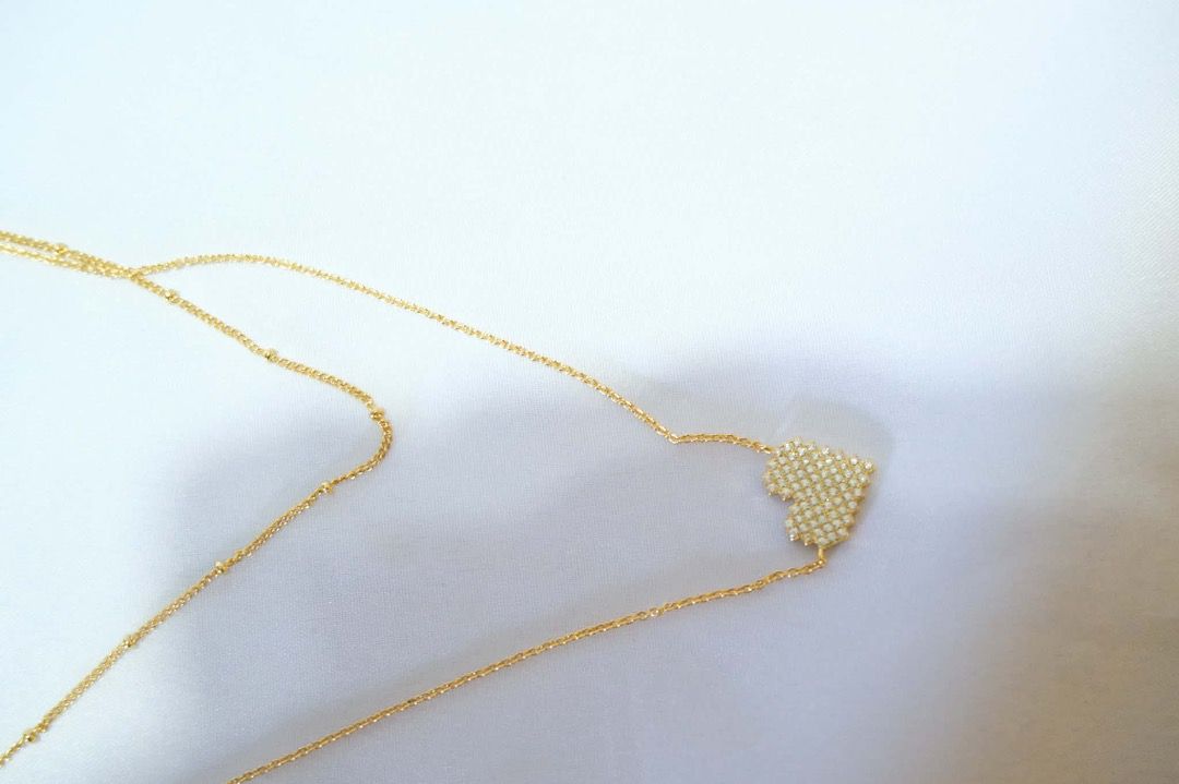Gold Heart Pendant Necklace (Category: Necklaces) located in Tarlac. Submitted by alleiz1521 (Listing ID 1437410831, Image 3). Description: - Gold double-layered chain necklace - Features a heart-shaped pendant - Adorned with sparkling crystals - Simple and sophisticated design - Suitable for casual and formal wear.