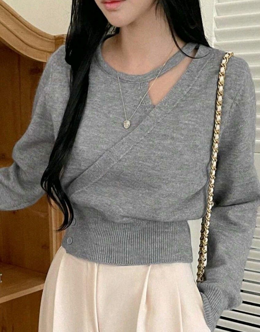 Gray Cutout Sweater (Category: Longsleeves) located in Taguig. Submitted by chicstyle (Listing ID 1434029391, Image 3). Description: - Gray sweater - Cutout neckline - Wrap-style design - Long sleeves - Ribbed hem - Button closure - Soft knit material.
