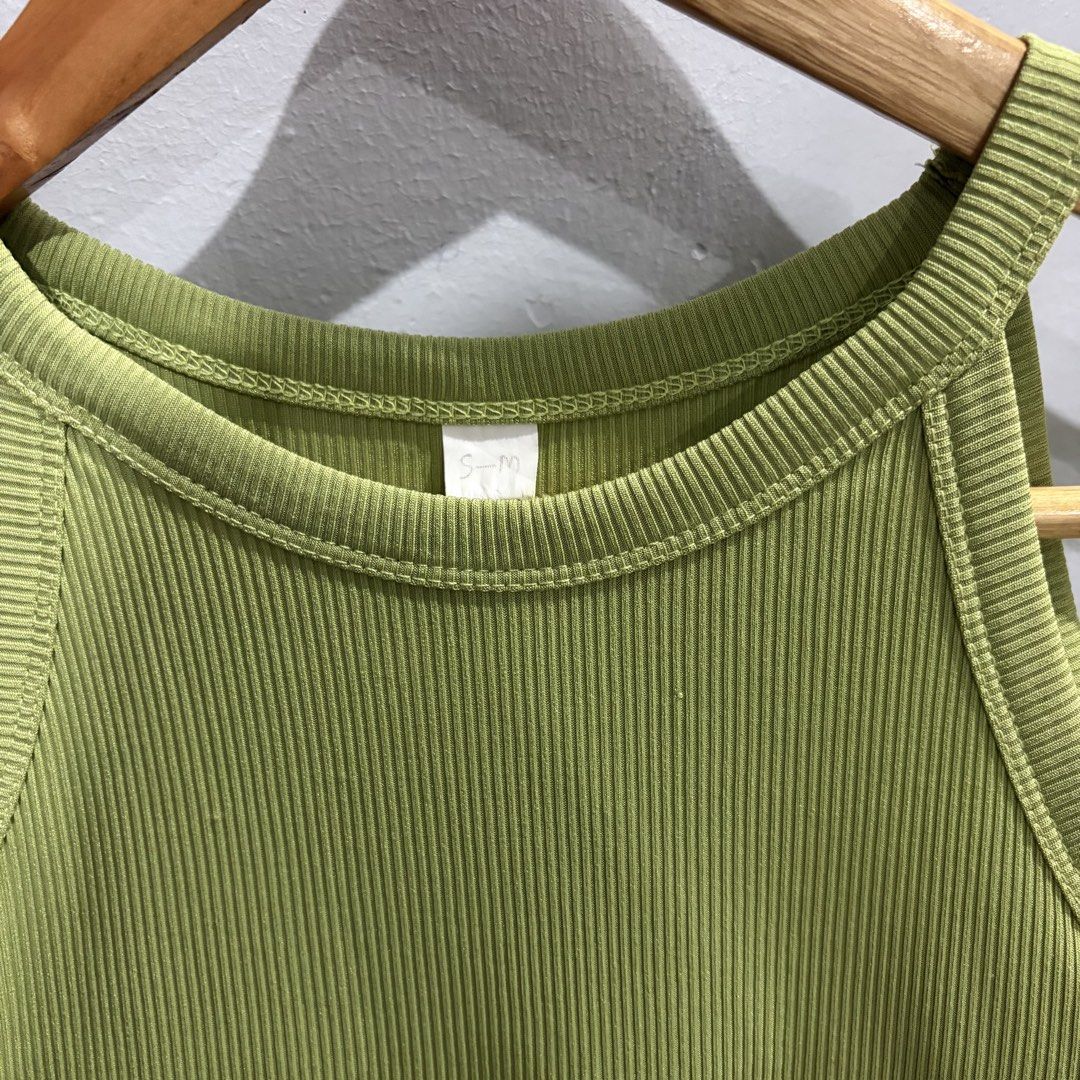 Green Ribbed Tank Top (Category: Sleeveless) located in Pateros City. Submitted by lovealy_07 (Listing ID 1437533053, Image 2). Description: - Green tank top - Ribbed texture - Halter neckline - Size: Small - Solid green color - Versatile for casual wear.