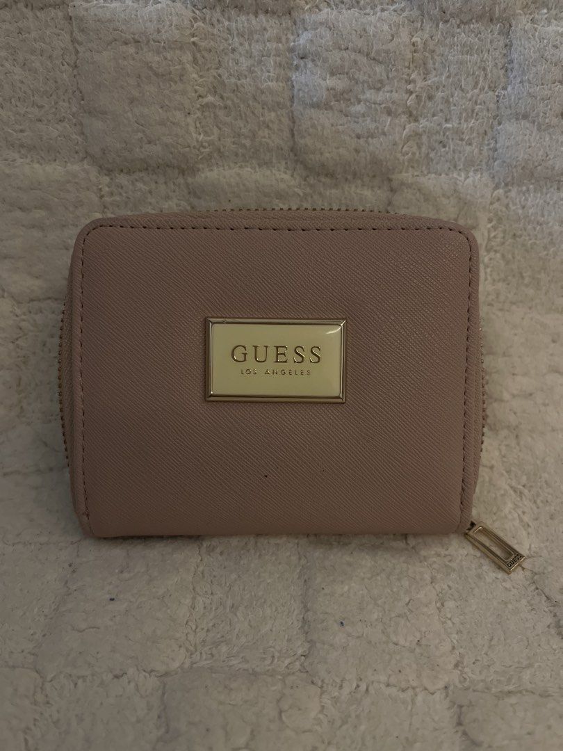 Guess Los Angeles Wallet (Category: Wallets & Card holders) located in Mandaluyong City. Submitted by declutterbykaye (Listing ID 1437521200, Image 1). Description: - Soft pink Guess wallet - Zip-around closure - Gold-tone Guess logo - Card slots and small compartment inside.