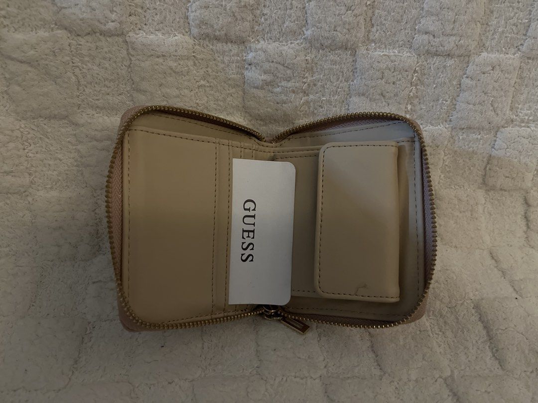 Guess Los Angeles Wallet (Category: Wallets & Card holders) located in Mandaluyong City. Submitted by declutterbykaye (Listing ID 1437521200, Image 2). Description: - Soft pink Guess wallet - Zip-around closure - Gold-tone Guess logo - Card slots and small compartment inside.
