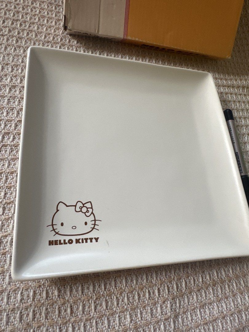 Hello Kitty Square Plate (Category: Dinnerware & Cutlery) located in Cainta. Submitted by shopbyyna (Listing ID 1437414143, Image 2). Description: - Kitty square plate - Features the Kitty logo - White plate color - Includes original box - Lawson logo and copyright information on the back.