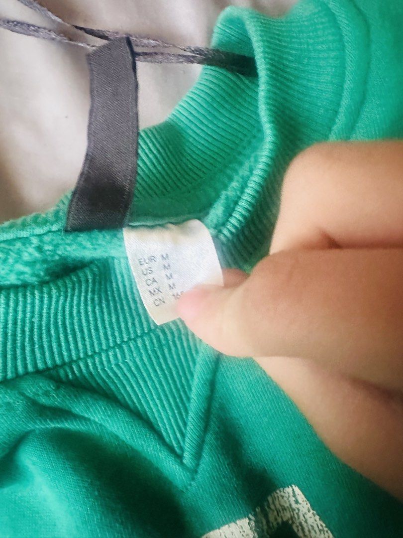 H&M Green Playoff Sweatshirt - Size M (Category: Longsleeves) located in Santa. Submitted by frinkmallooo (Listing ID 1437417758, Image 3). Description: - H&M "Playoffs" sweatshirt - Size: Medium - Color: Green - Features: Crew neck, long sleeves, ribbed hem and cuffs - Condition: Minor stain on sleeve - Fabric: Comfortable for casual wear issue : brown stain (check sa other pics).
