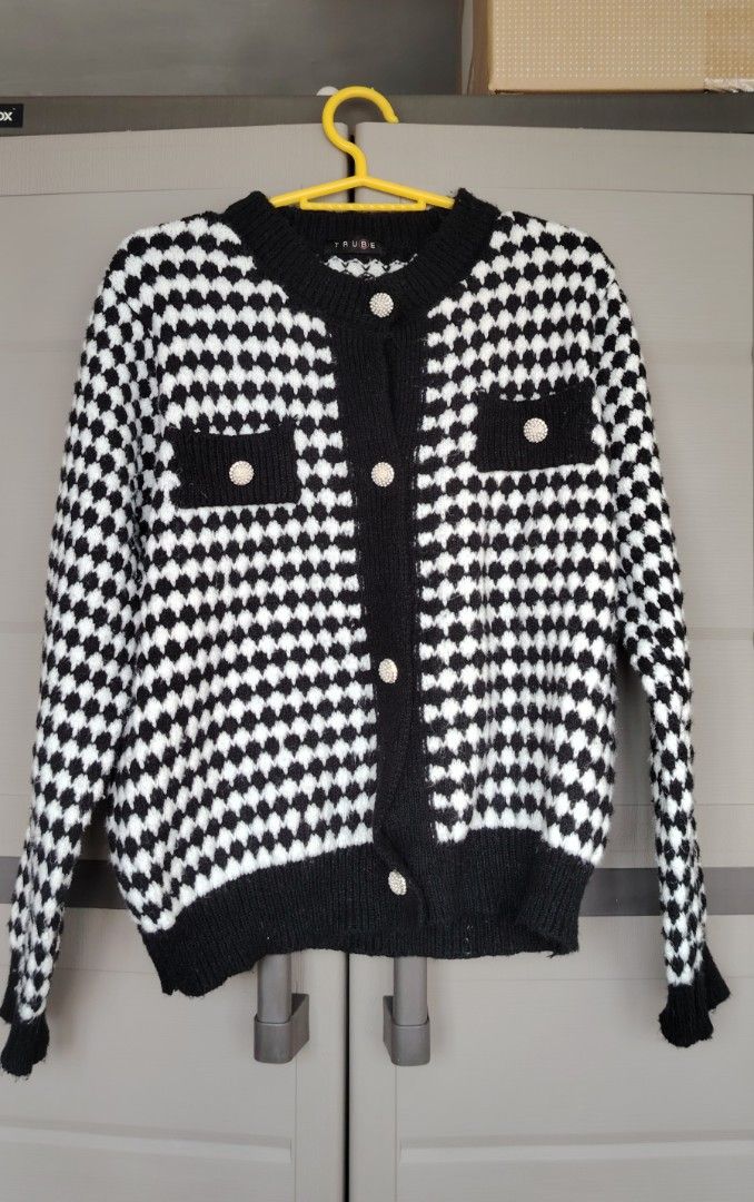 Knitted Cardigan Black and White (Category: Coats, Jackets and Outerwear) located in Mandaluyong City. Submitted by trisha_001 (Listing ID 1437567587, Image 2). Description: - Stylish black and white checkered cardigan - Classic pattern and round neckline - Button-down closure - Long sleeves with black cuffs - Black trim along the hem.
