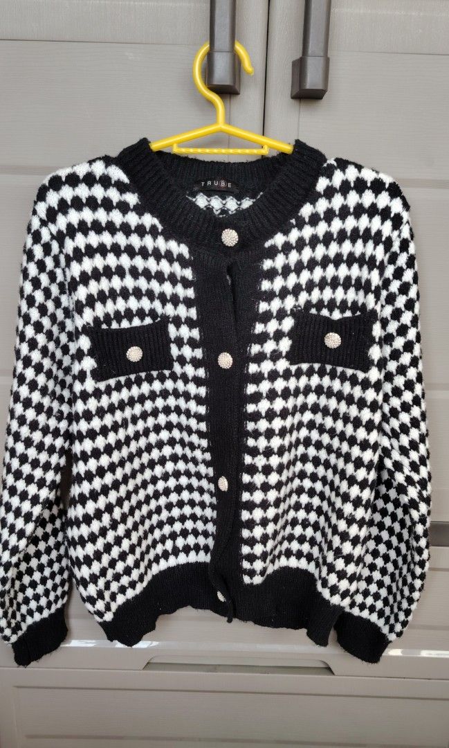 Knitted Cardigan Black and White (Category: Coats, Jackets and Outerwear) located in Mandaluyong City. Submitted by trisha_001 (Listing ID 1437567587, Image 1). Description: - Stylish black and white checkered cardigan - Classic pattern and round neckline - Button-down closure - Long sleeves with black cuffs - Black trim along the hem.