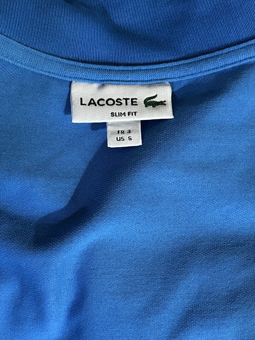 Lacoste Slim Fit Polo Shirt (Category: Tshirts & Polo Shirts ) located in Manila. Submitted by boldtree_947e32 (Listing ID 1437580868, Image 3). Description: - Authentic Lacoste polo shirt - Vibrant blue color - Slim fit design - Size: FR 3 / US 5 - Iconic Lacoste crocodile logo - Made with quality materials - Suitable for casual and semi-formal wear.