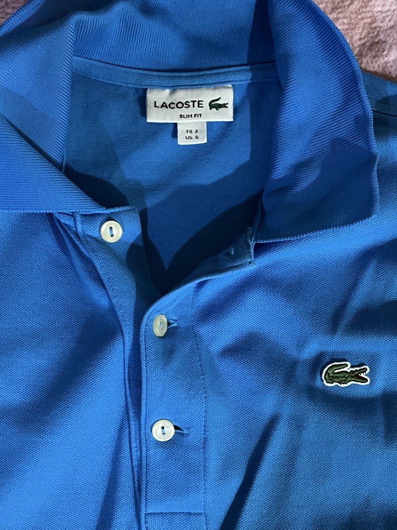 Lacoste Slim Fit Polo Shirt (Category: Tshirts & Polo Shirts ) located in Manila. Submitted by boldtree_947e32 (Listing ID 1437580868, Image 2). Description: - Authentic Lacoste polo shirt - Vibrant blue color - Slim fit design - Size: FR 3 / US 5 - Iconic Lacoste crocodile logo - Made with quality materials - Suitable for casual and semi-formal wear.