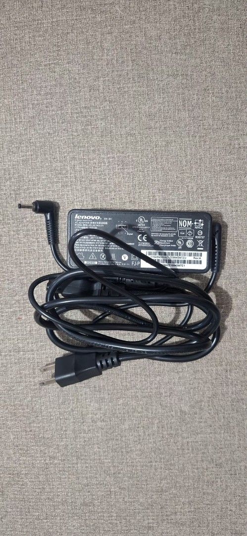 Lenovo Laptop Charger (Category: Chargers) located in Valenzuela. Submitted by kristina_r.2026 (Listing ID 1437508039, Image 1). Description: Lenovo laptop charger 65 W, round tip, standard Philippine plug.