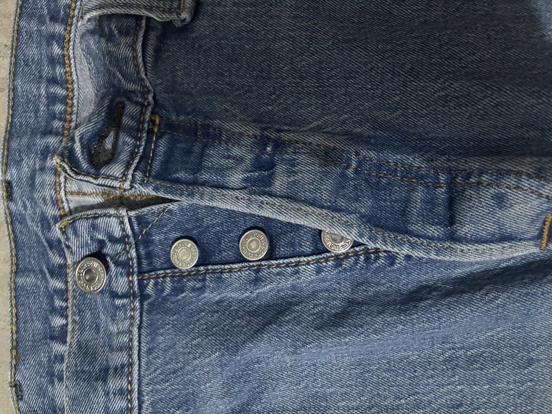 Levi's 501 Button Fly Jeans (Category: Jeans) located in Manila. Submitted by jiahhncarl57791 (Listing ID 1437491284, Image 3). Description: Classic Levi's 501 jeans with a button fly. Features the iconic Levi's red tab on the back pocket. The jeans have a light blue wash and a straight leg fit. Includes the classic five-pocket design. The tag indicates the jeans were made in Egypt..