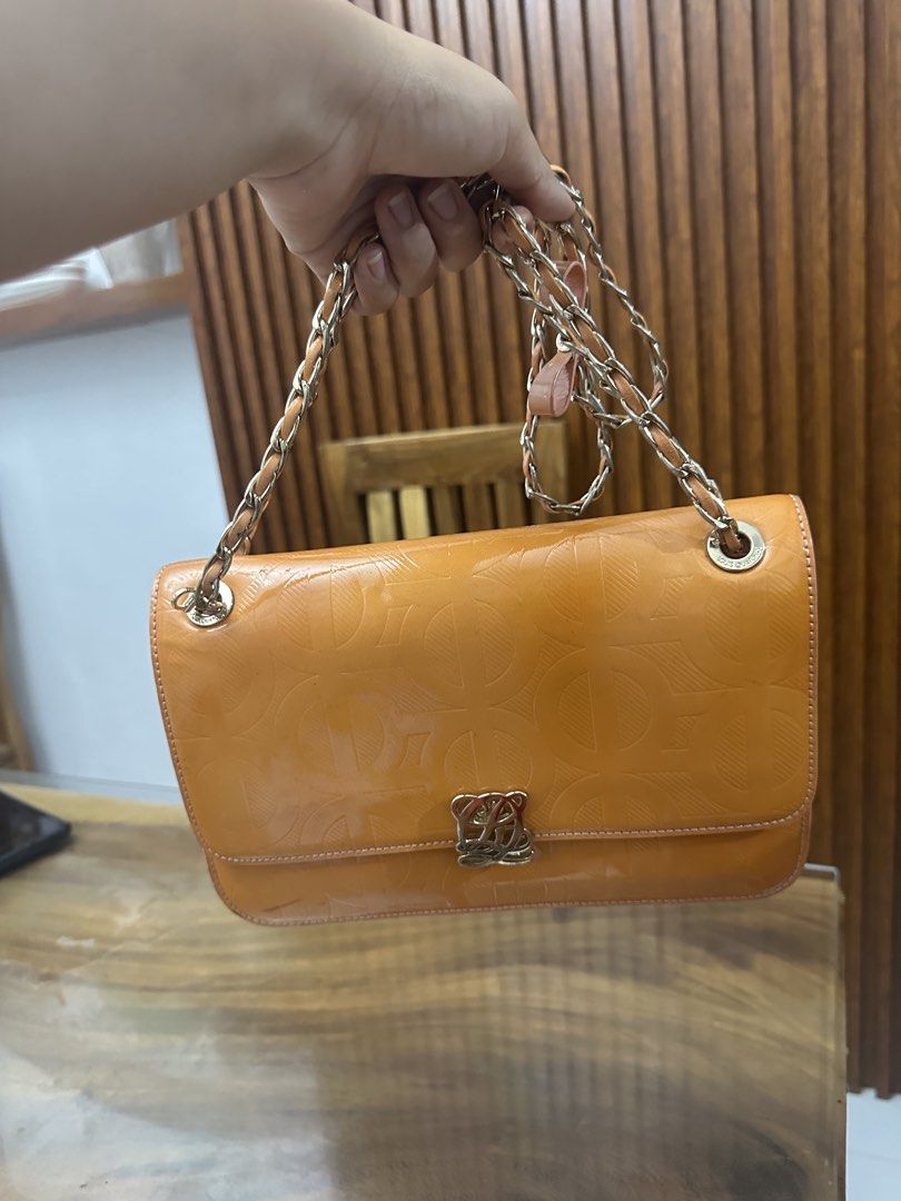 Louis Quatorze Shoulder Bag with Chain Strap (Category: Luxury Bags & Wallets) located in Batangas. Submitted by jhinp0t (Listing ID 1437500436, Image 2). Description: - Loewe shoulder bag - Vibrant orange color - Chain strap - Signature Loewe logo clasp - Embossed pattern - Small bow detail - Rectangular shape - Flap closure Issues: may color transfer see posted pictures gold pa hardwares .