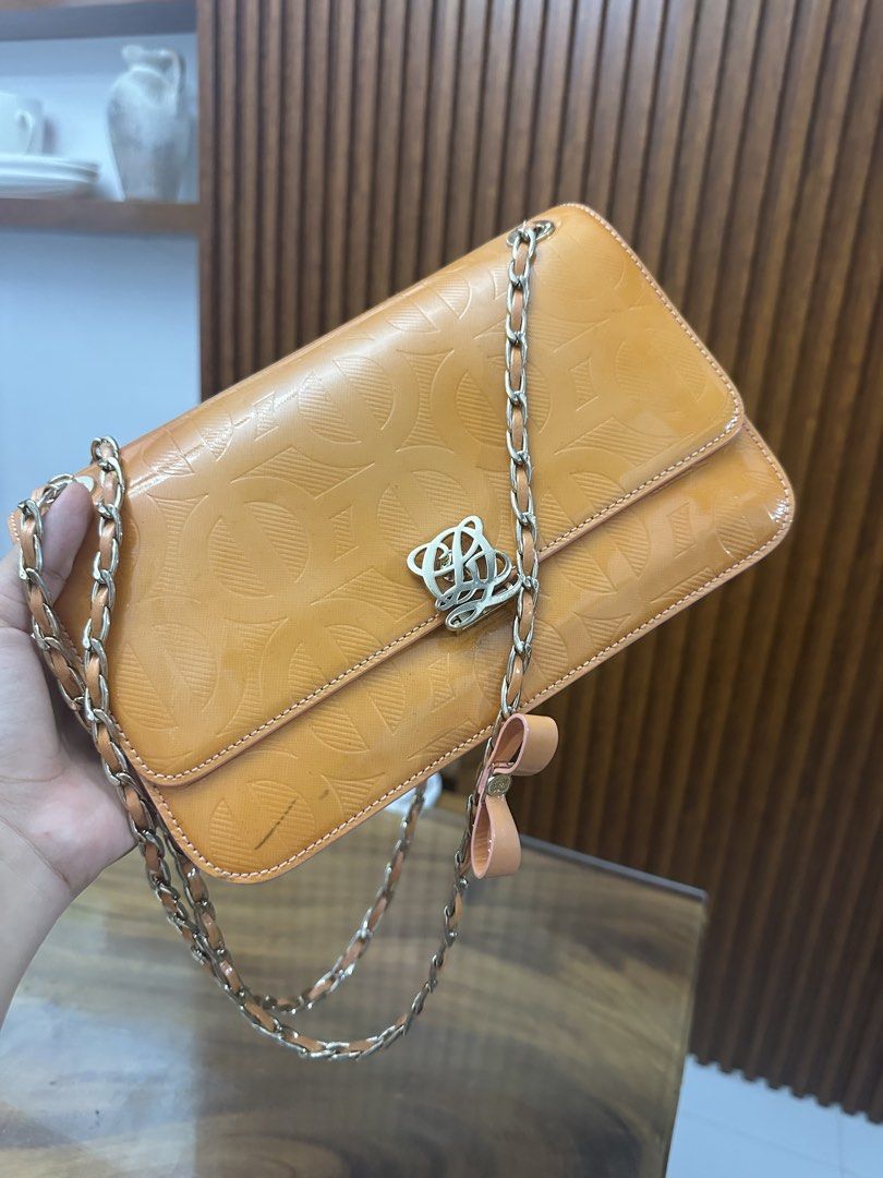 Louis Quatorze Shoulder Bag with Chain Strap (Category: Luxury Bags & Wallets) located in Batangas. Submitted by jhinp0t (Listing ID 1437500436, Image 3). Description: - Loewe shoulder bag - Vibrant orange color - Chain strap - Signature Loewe logo clasp - Embossed pattern - Small bow detail - Rectangular shape - Flap closure Issues: may color transfer see posted pictures gold pa hardwares .