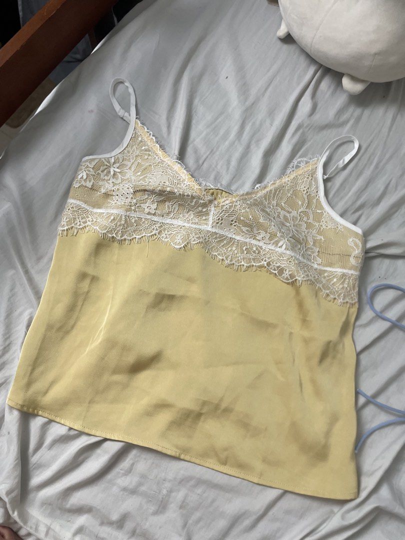 Maija Yellow Spaghetti Lace Strap Cami Top (Category: Sleeveless) located in Antipolo. Submitted by declutterandthrifts (Listing ID 1437538265, Image 3). Description: - Brand: Maija - Worn once - Size: XS - Style: Cami top - Color: Yellow - Features: Spaghetti straps, V-neck, lace detail - Material: 100% polyester - Texture: Satin-like lower part - mod of payment: gcash, maya and go type dm for more questions, and will reply right away :).