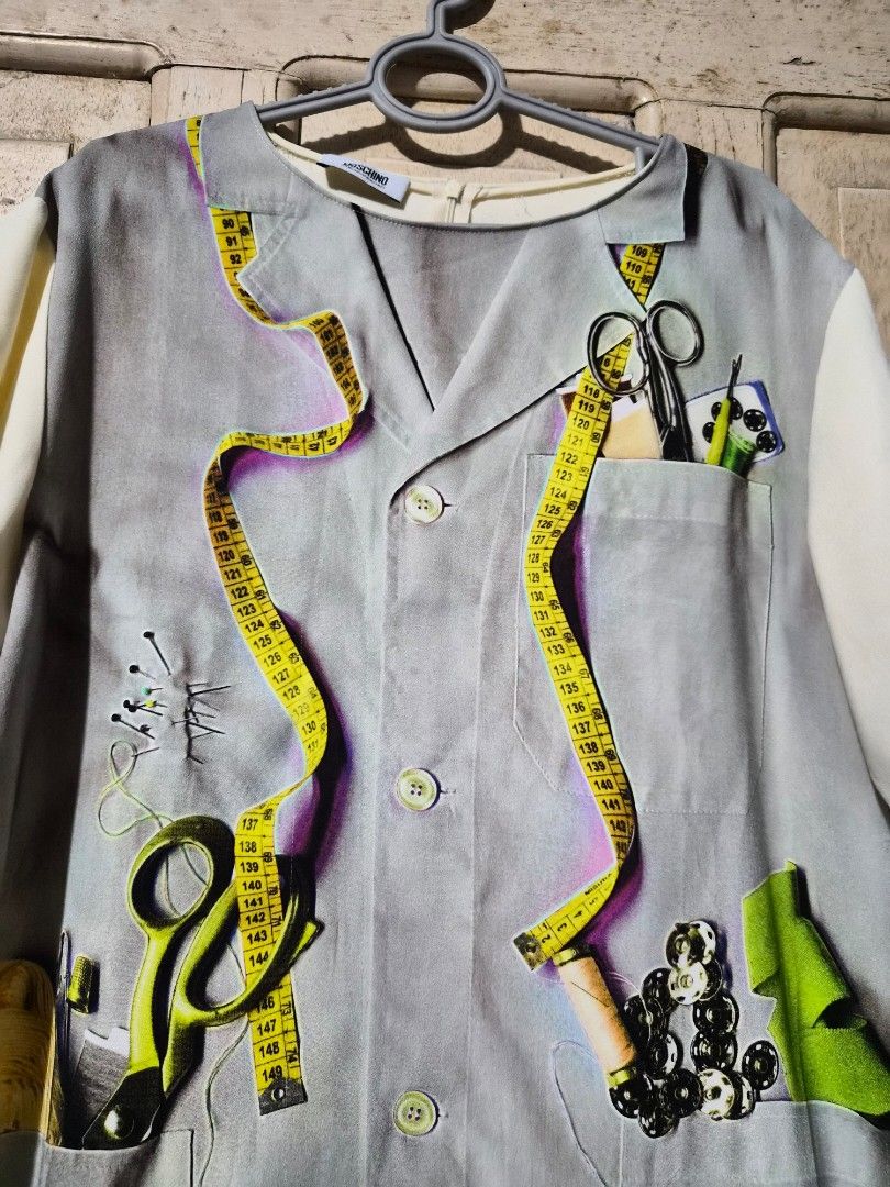 Moschino Cheap & Chic Multicolored Printed Crepe Blouse L (Category: Everything Else Others) located in Mandaue City. Submitted by chuchi152615 (Listing ID 1437406907, Image 3). Description: - Moschino Cheap & Chic blouse - Unique print featuring sewing tools - Size: L - Collared neckline - Short sleeves - Button-down front - Plain white back with zipper closure - White sleeves.
