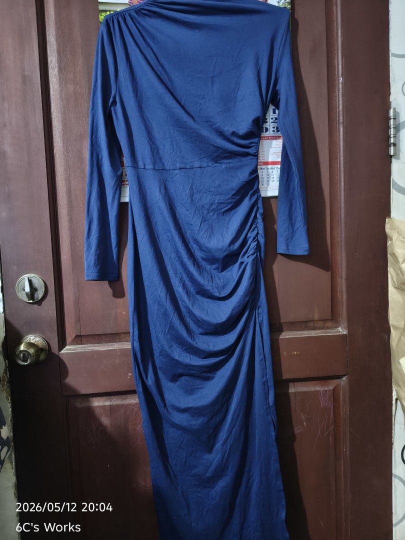 Navy Blue Long Sleeve Dress (Category: Dresses) located in Consolacion. Submitted by mencytte (Listing ID 1437519630, Image 1). Description: Elegant navy blue dress with long sleeves and side slit. Features a ruched design on the side, adding a flattering silhouette. The dress has a cowl neckline. Perfect for a night out or a special occasion. Made from a soft, flowing fabric that drapes beautifully. can fit small to medium.