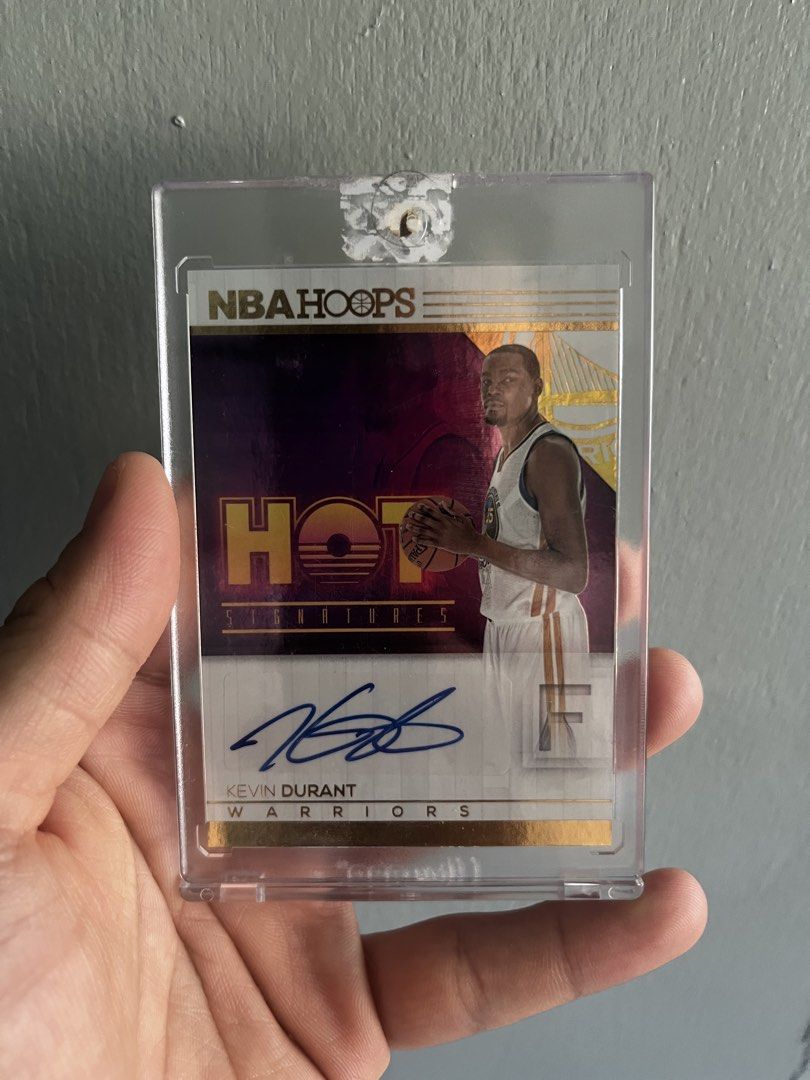NBA Hoops Kevin Durant Autograph Card (Category: Raw Singles) located in Manila. Submitted by allaboutthemhobbies_ (Listing ID 1437488158, Image 1). Description: - 2016-17 NBA Hoops Trading Card - Features Kevin Durant - "Hot Signatures" Autograph Card - Numbered 59 - Comes with a protective case.